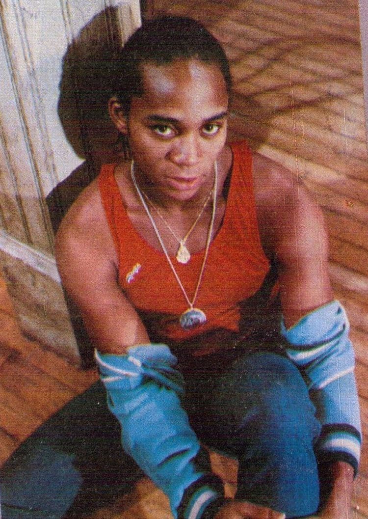 Young Gene Anthony Ray sitting on a Harlem stoop